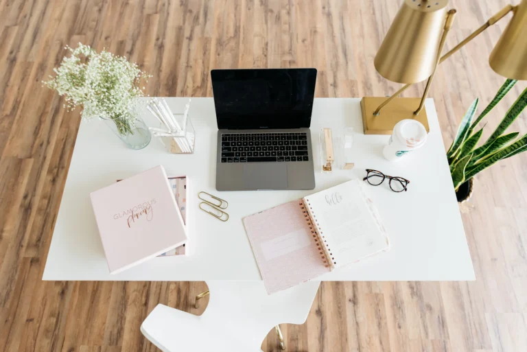 Schreibtisch mit Laptop, Notizbuch und Schreibmaterial